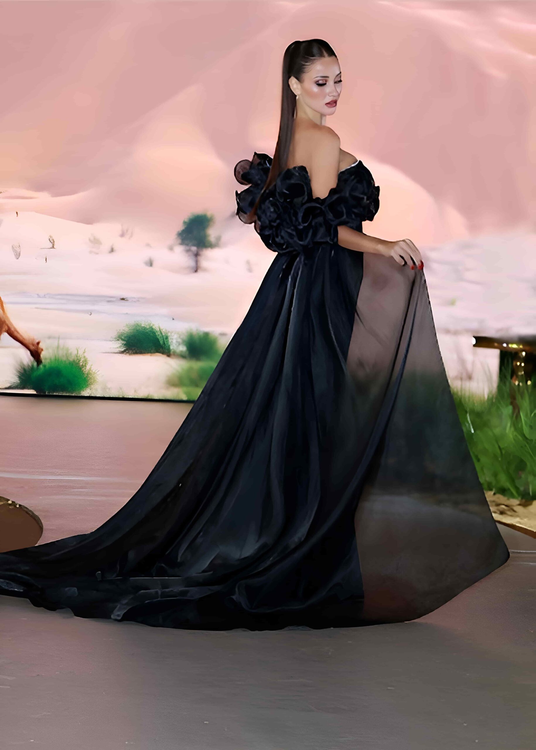 Elegant woman in black gown posing in Dubai city